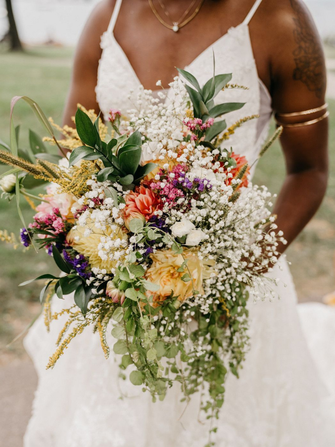 Bride holding wildflower bouquet with baby's breath