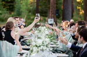 Wedding Guests Toasting With Wine Glasses During Reception Speeches