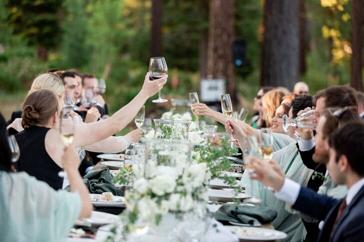 Wedding Guests Toasting With Wine Glasses During Reception Speeches