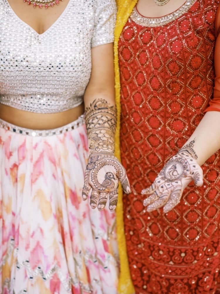 hands decorated with henna patterns