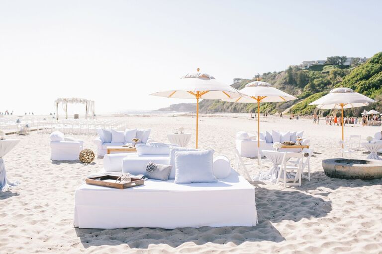 White lounge furniture and umbrellas on beach