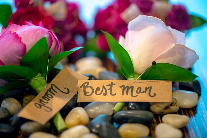 A fuchsia peony boutonniere popped against Tim's custom suit, while a blush rose adorned his best man's lapel.
