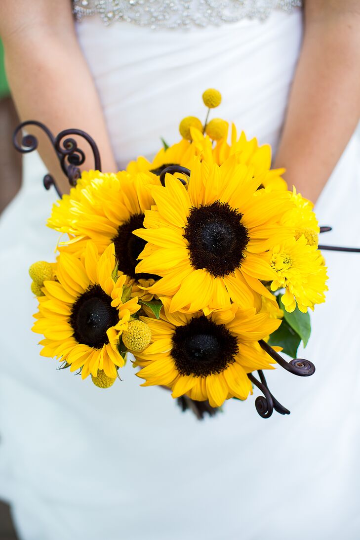 Caitlin carried a bouquet with sunflowers, fiddlehead ferns, craspedia and yellow chrysanthemums.