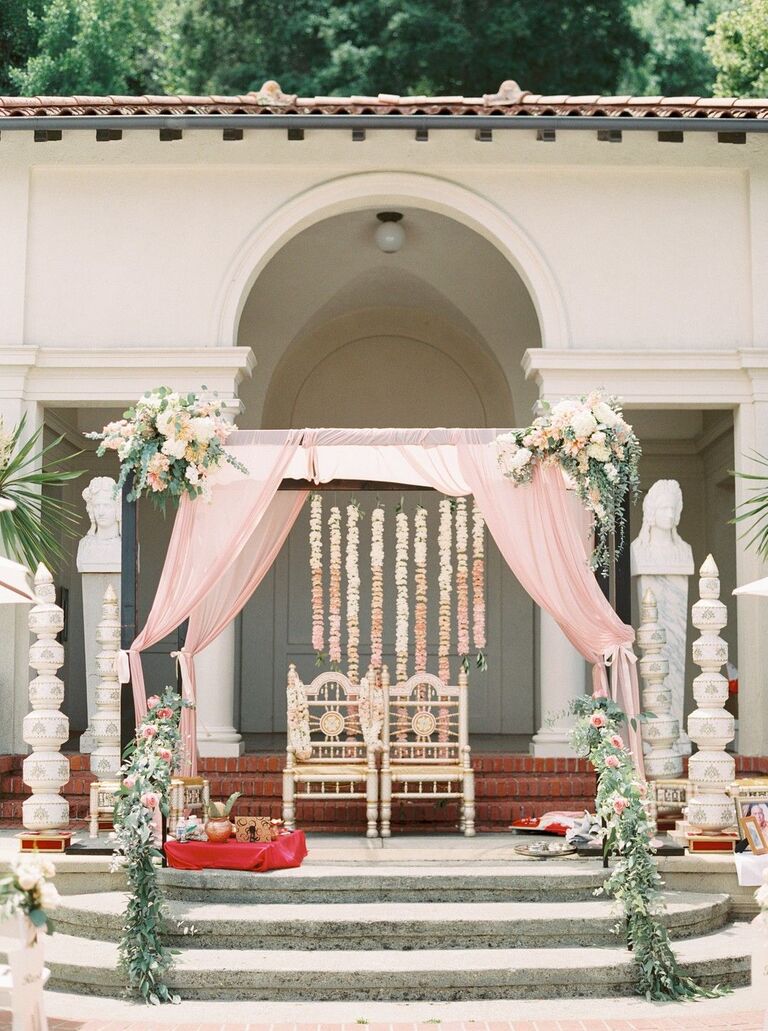 Romantic mandap with blush draping and greenery accents