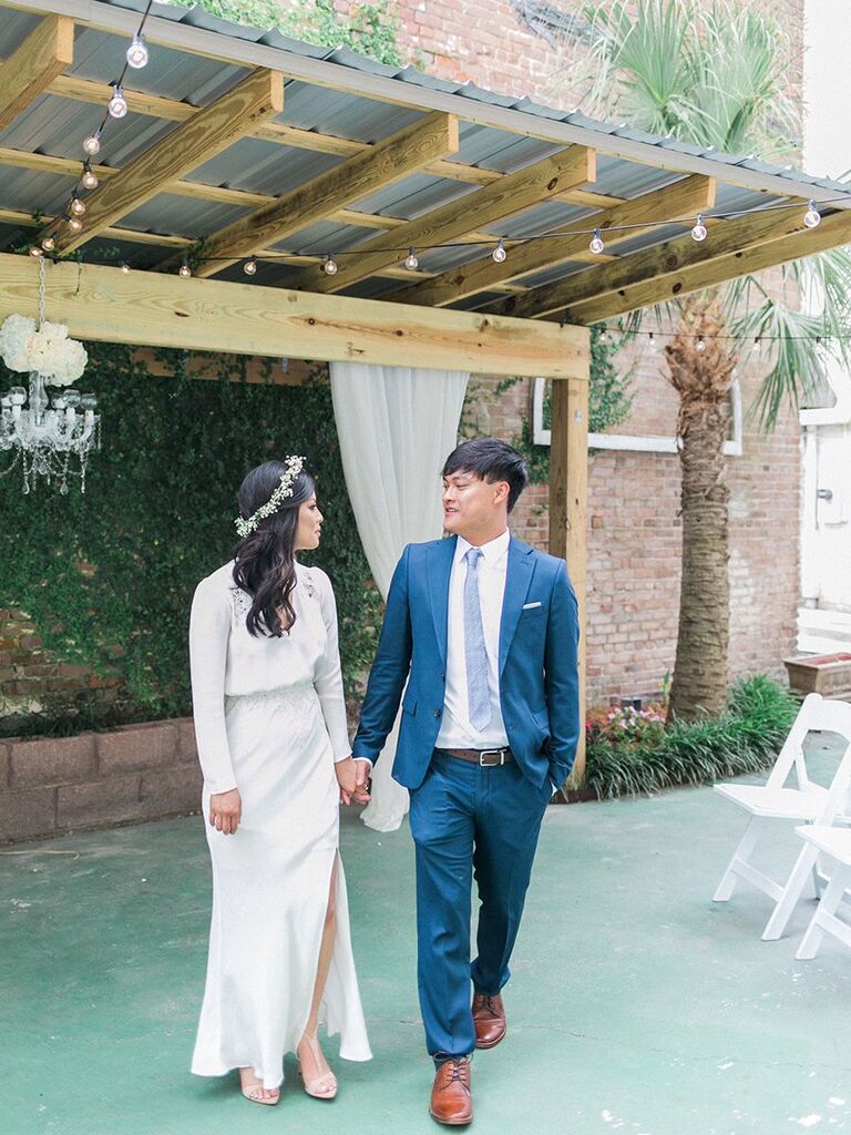 bride and groom holding hands