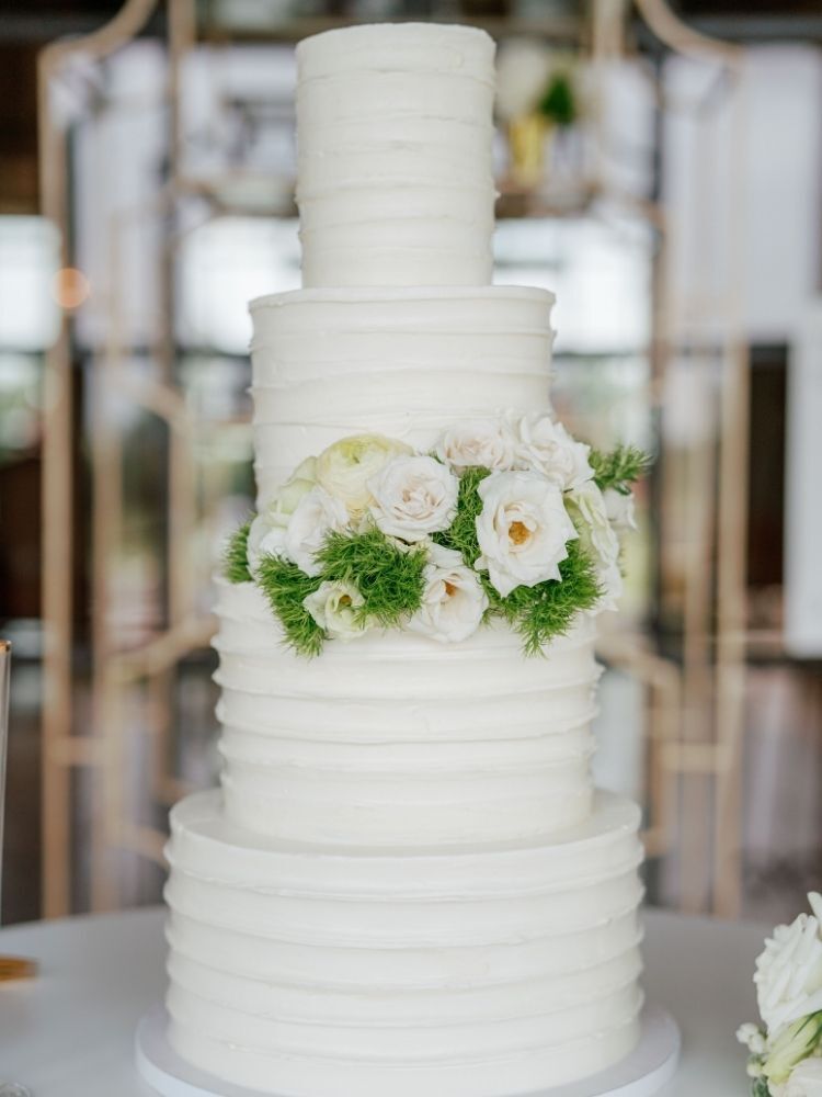 simple four-tier spring wedding cake with fresh flowers