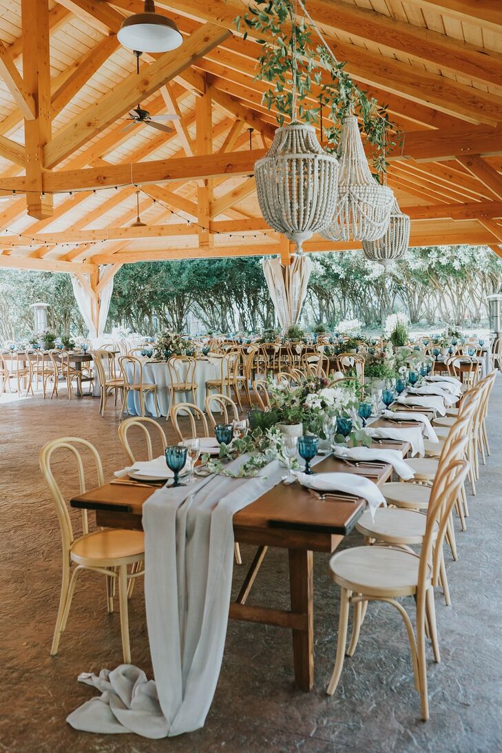 Linen Table Runner, Wicker Chairs and Lush Greenery at Wedding Reception