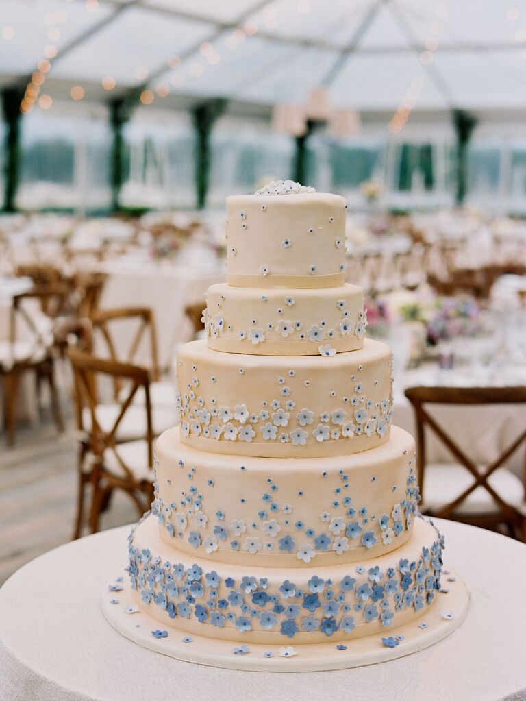 five tier white fondant cake decorated with blue ombre sugar flowers