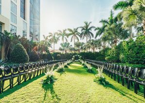 Outdoor Reception, Lawn, Runway Setup With Lots of Greenery, Black Chairs