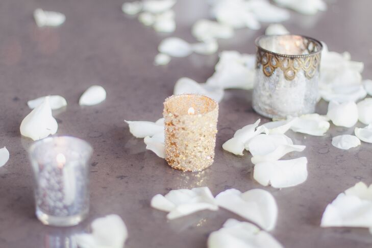 The ceremony took place in front of a marble table that was adorned with various embellished candle holders and scattered petals.