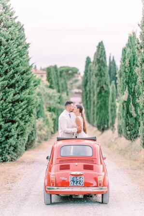 Couple Sharing Kiss in Red Getaway Car at Terre Di Nano in Val d’Orcia, Italy