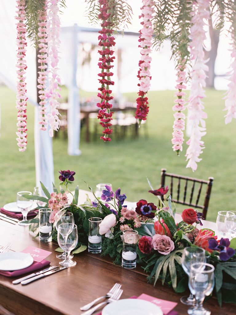 wedding reception tablescape with hanging centerpiece and tropical flowers