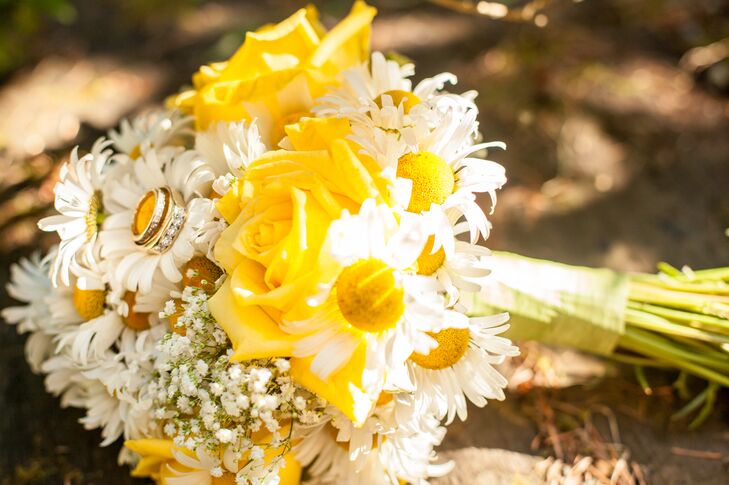 The bridal bouquet was a mix of yellow roses and ditch daisies, accented with baby's breath. “My favorite flowers have always been ditch daisies, the ones that grow along the freeway,” says Jessica. “Those were my flowers and the color scheme for the wedding. I added accents of blue for the "something blue" tradition of old days.”