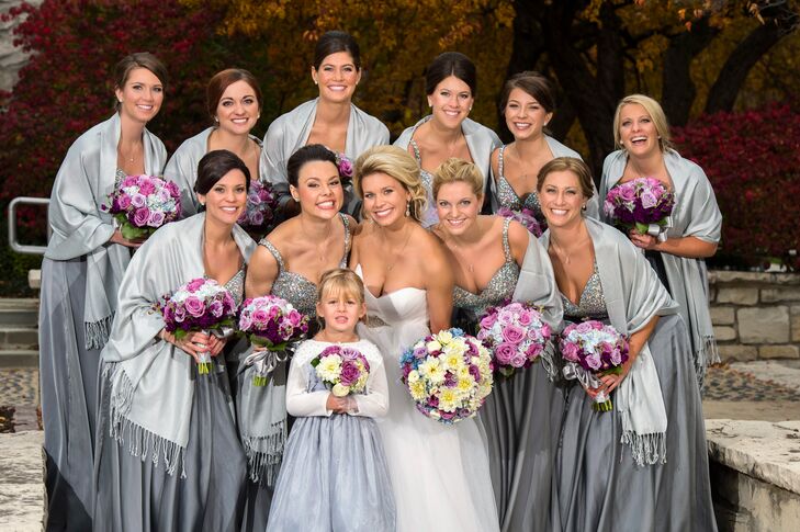 Jenna couldn't find the bridesmaid dresses she envisioned, so she custom-ordered them in platinum. It had a bodice covered in rhinestones, which trailed down into a flowing platinum silver skirt. The color provided a neutral canvas for the blue, pink and lavender flowers in the bridesmaid bouquets.