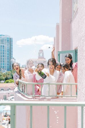 Bride and Bridesmaids Popping Bottle of Champagne at The Vinoy Renaissance in St. Petersburg, Florida