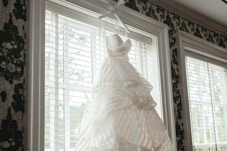 Elon found a strapless ivory wedding dress with a sweetheart neckline in a striped pattern going all the way down the layered ball gown skirt, which she fell in love with and wore for the wedding. "All the dresses she tried on were amazing, but the one that stood out was definitely the striped gown from Hayley Paige," the couple says. "She knew it was the one!"