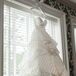Elon found a strapless ivory wedding dress with a sweetheart neckline in a striped pattern going all the way down the layered ball gown skirt, which she fell in love with and wore for the wedding. "All the dresses she tried on were amazing, but the one that stood out was definitely the striped gown from Hayley Paige," the couple says. "She knew it was the one!"