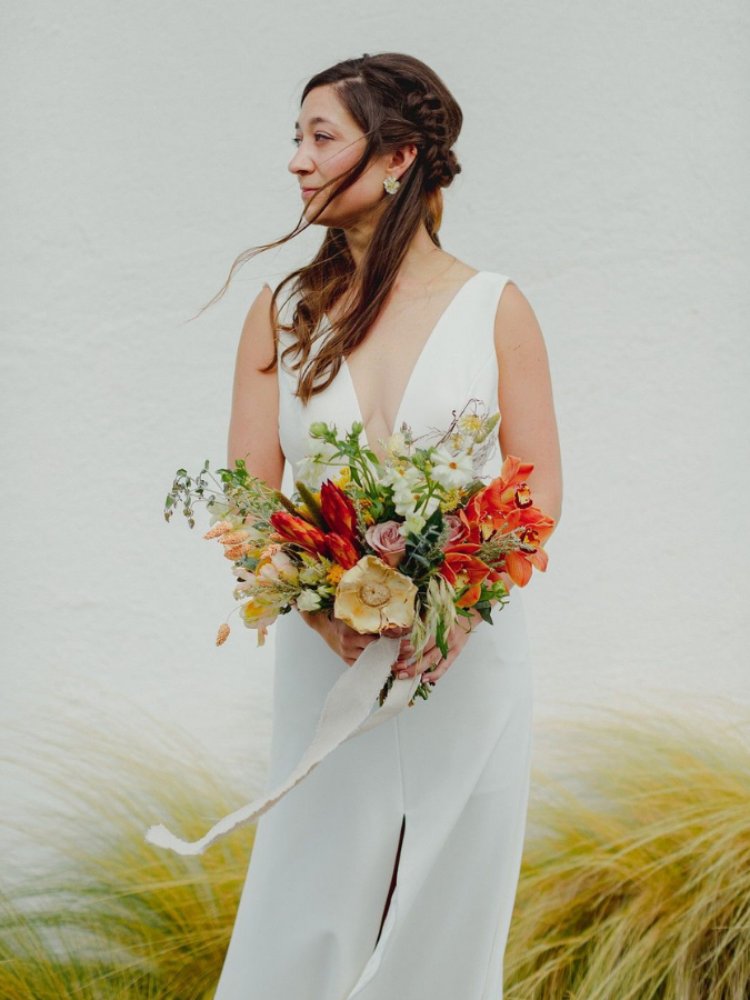 Bride holding red bouquet