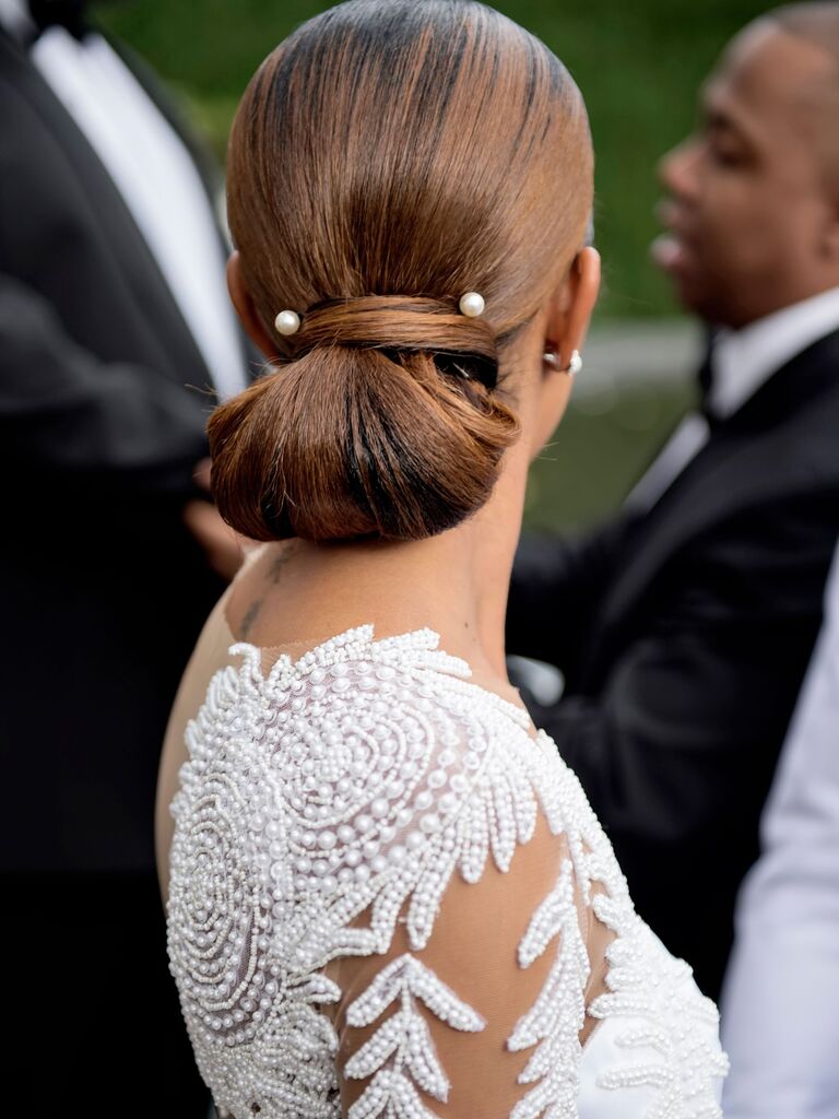 Pearl hair pins in a bride's updo. 
