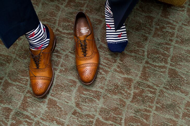The groom accessorized his navy blue suit with nautical accents like a colorful Vineyard Vines tie and blue and white socks with lobster embroidery,  to play up the feel of the Nauticus Marina, where the bride and groom had their reception.