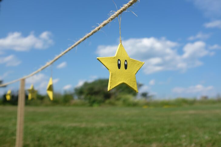 Handmade super stars were string along a piece of twine for the outdoor wedding decor.
