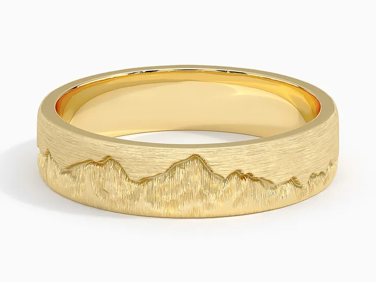 gold band with mountain design engraved