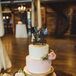 Laura and Levi’s cake from Madison’s on Main embodied the garden glam theme. It had a metallic gold tier in the center of blush and ivory tiers accented by garden roses, and a whimsical skull cake topper in black.