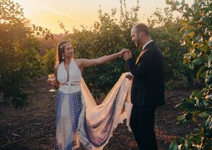 Groom in Suit Kissing Bride's Hand, Multi-Piece Outfit, Halter Top, Overskirt, Long Veil, Gold