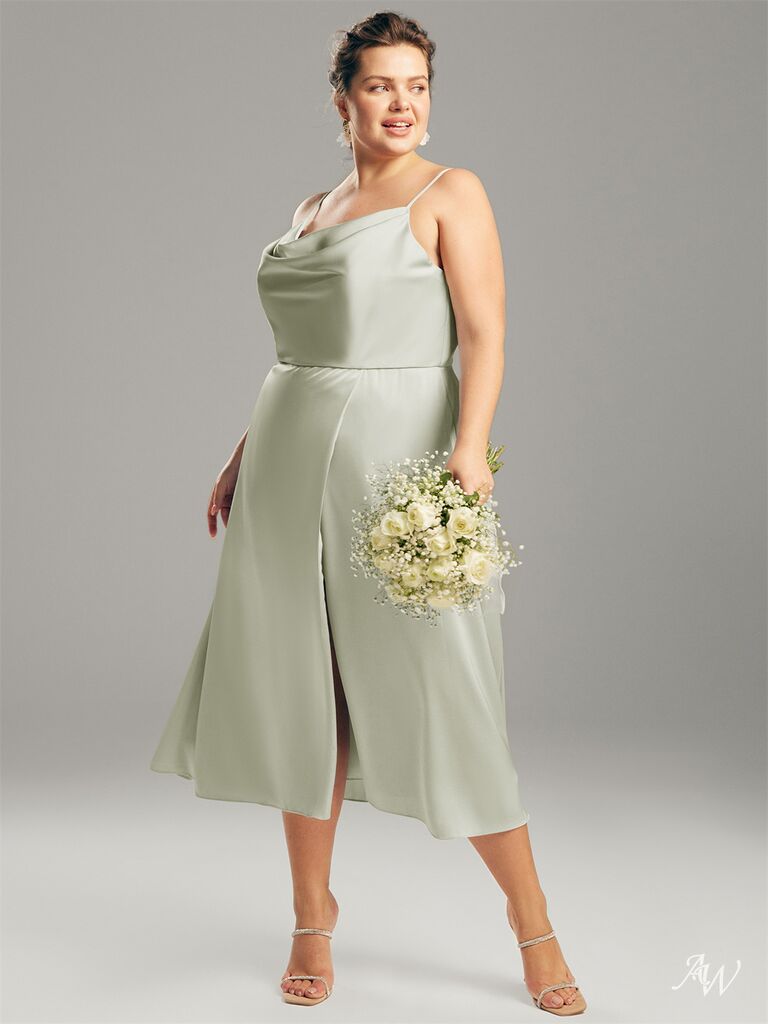 Model wears a silk sage green gown.
