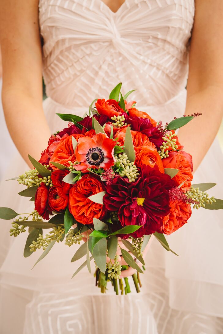 The bride carried a stunning red bouquet of anemones, garden roses, ranunculus and dahlias.