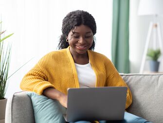 Bride writing wedding website FAQs for her wedding guests