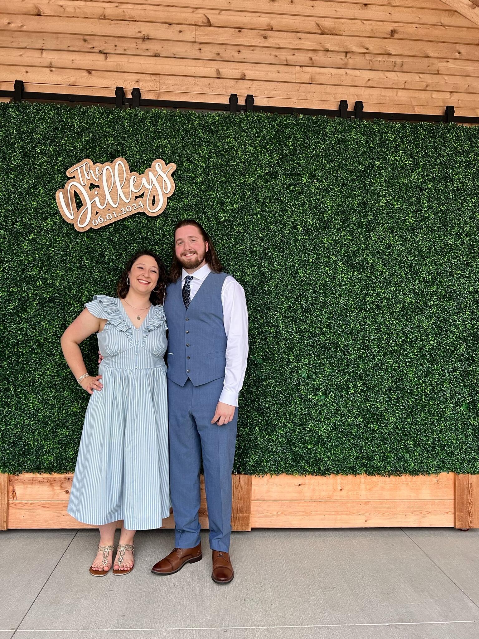 Posing in front of the Dilley sign at Jake and Liv's wedding!