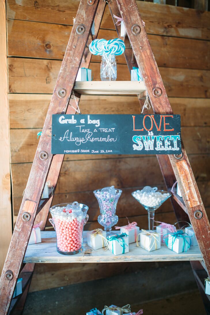 During the reception, guests wandered into the barn to pick out sweets and treats from the "candy store" display. They picked from a range of candy and cupcakes boxed in colorful packaging, with a chalkboard sign that read "Love Is Sweet."