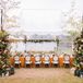 Tented Reception With Orange Linens and Upholstered Chairs in Chadbourn, North Carolina