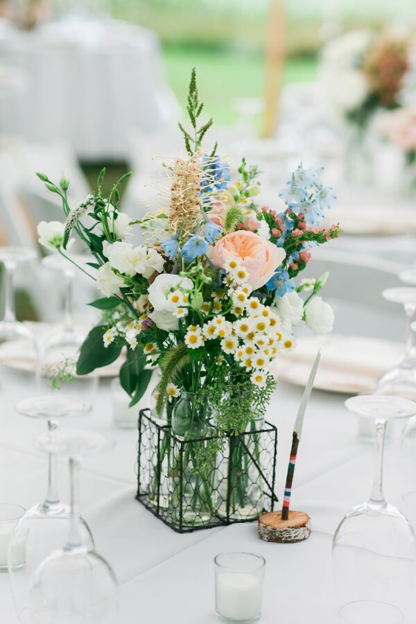 Jordan’s mother, the genius behind Seagrass Florals, channeled the wild feel of the gardens at Megan’s parents' home in North Yarmouth, Maine. Each arrangement was filled with a mix of colorful wildflowers and classic pastel blooms.