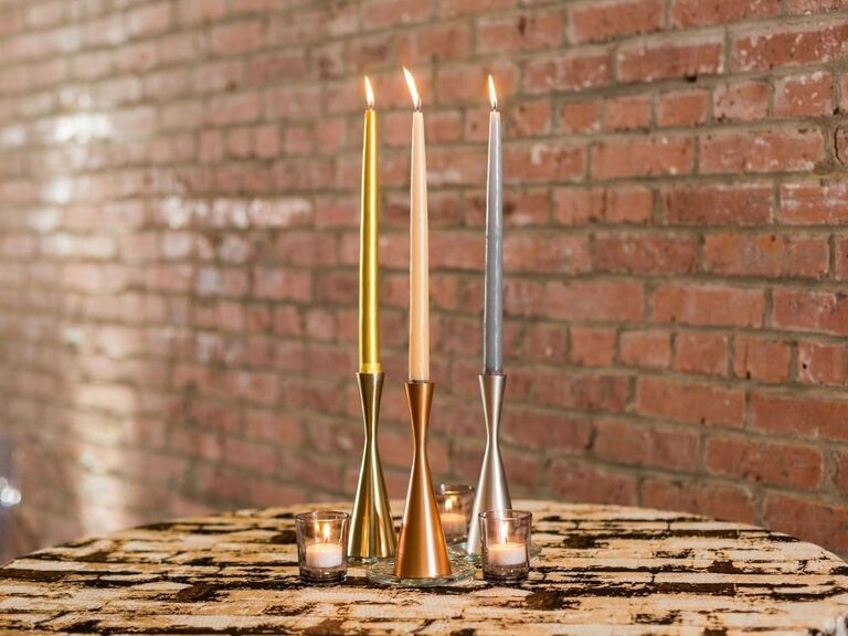 colorful taper candles in metal candle holders