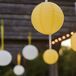 White and yellow paper lanterns hung above the couple during the ceremony.
