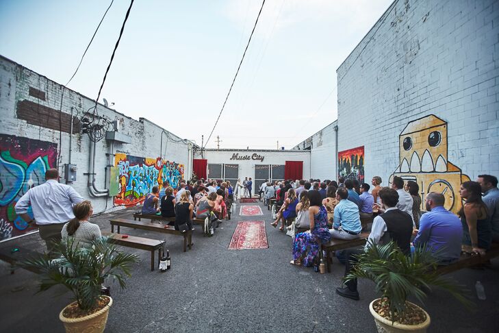 The ceremony took place outside the warehouse, in front of the garage doors. With colorful graffiti on the walls, decorations were minimal.