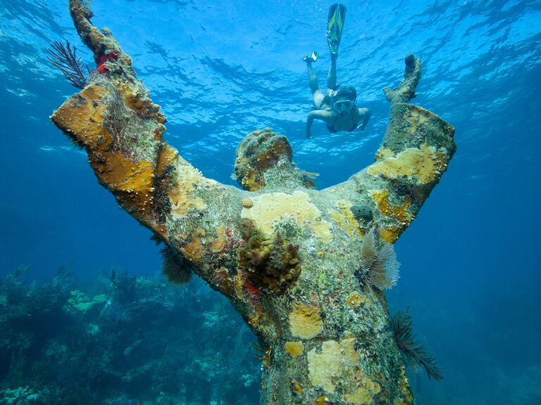 Underwater Christ of the Abyss statue near Key Largo with scuba diver in background