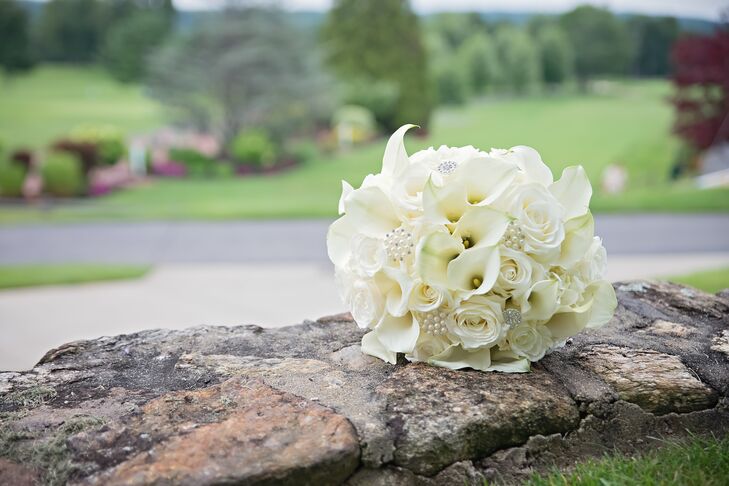 Mariel carried an ivory bouquet including roses, calla lilies and hydrangeas. She accented the flowers with glamorous pearl and crystal accents to match the sparkly theme of the wedding. Mariel wanted all the floral arrangements to exude romance, and Ray's Flower Shop did a wonderful job bringing her vision to life.