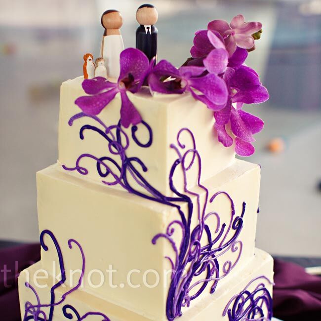 The mod square cake (decked out in the same glass art pattern as the invites) got a dose of playfulness from custom wooden peg toppers.
