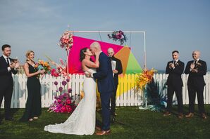 Bride and Groom In Front of Graphic Wedding Arch