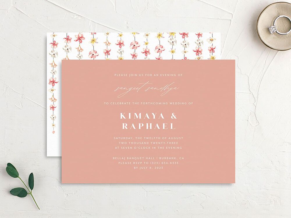Pastel orange background with white type and colorful hanging florals on envelopePastel orange background with white type and colorful hanging florals on envelope