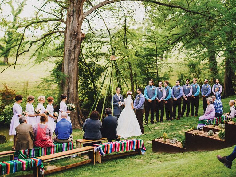 outdoor wedding ceremony under tipi structure
