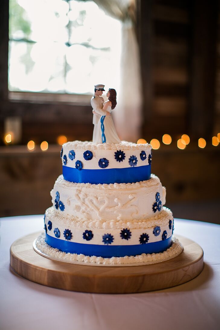 Josh's mother made the ivory wedding cake, which was decorated with blue sugar flowers and ribbon around the base of the layers. A bride and groom figurine set resembling Justine and Josh served as the cake topper.