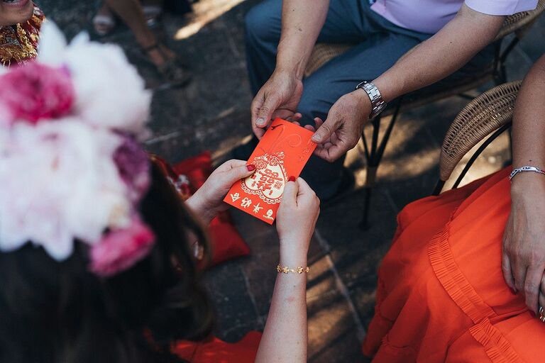 Red envelope being passed during Chinese wedding ceremony