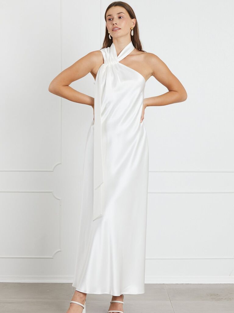 Model wears a chic silk down with a halter-style neckline. 