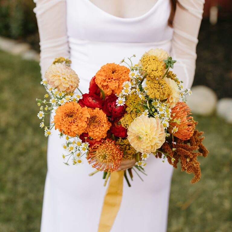 Marigold and protea bouquet in orange tones