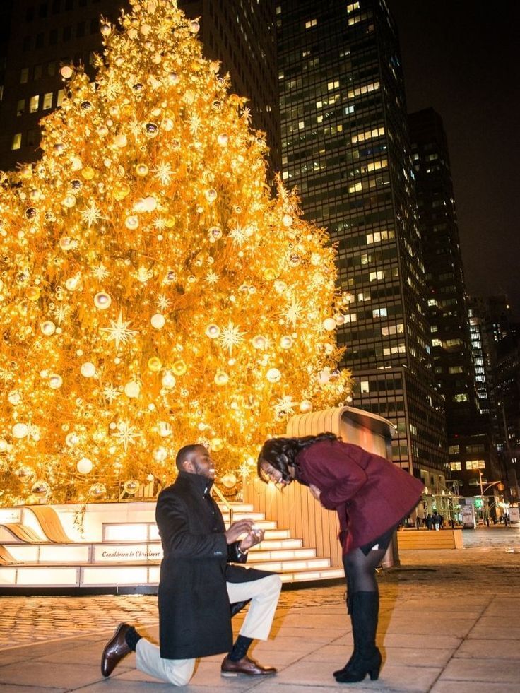 Christmas marriage proposal in front of Christmas tree