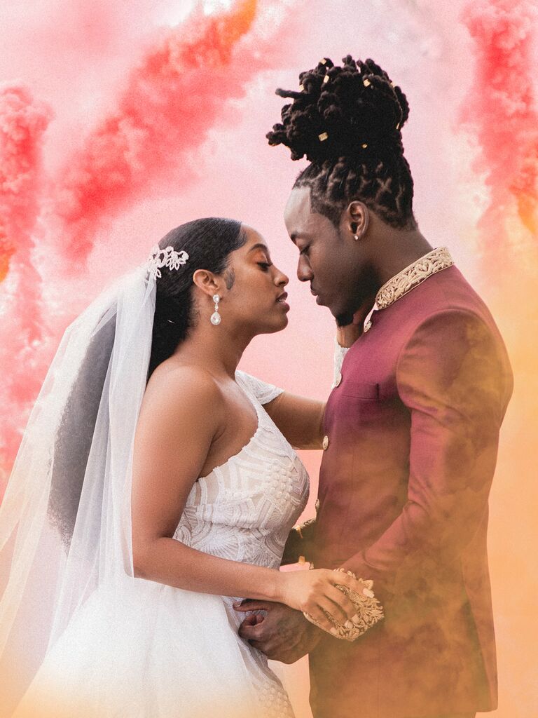 Couple looking at each other in front of colorful smoke